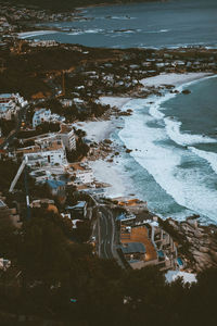 High angle view of cityscape by sea against sky