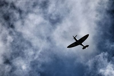 Low angle view of airplane flying in sky