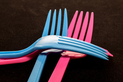 High angle view of multi colored pencils on table against black background