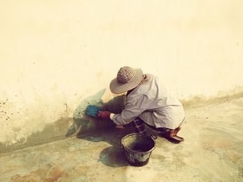 High angle view of mature man cleaning wall