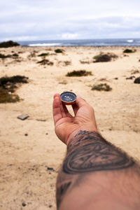 Cropped hand of person holding coin