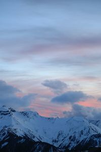 Scenic view of snowcapped mountains against sky during sunset