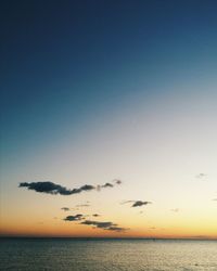 Scenic view of sea against clear sky at sunset