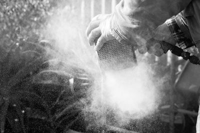 Cropped image of worker removing dust