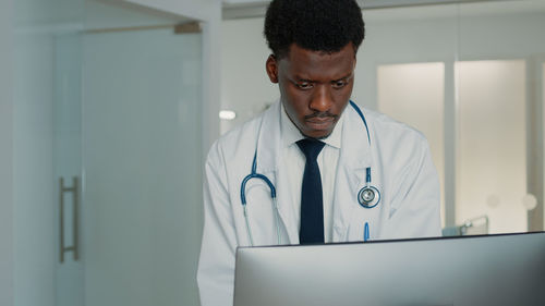 Doctor working on laptop at hospital