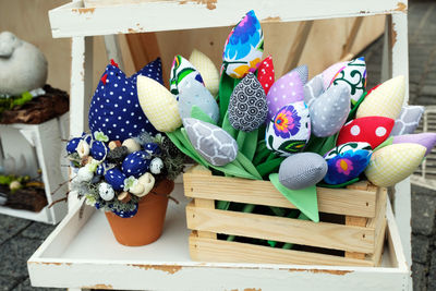 Blue, white and red sewn spring flowers on display at a local arts and crafts market