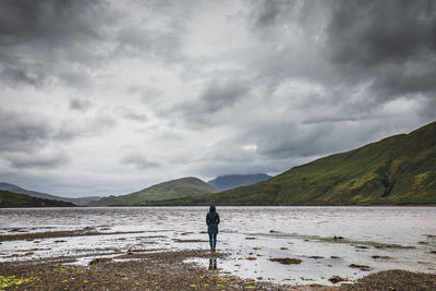 Man standing on beach against sky