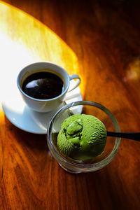 High angle view of coffee and green tea ice cream on table