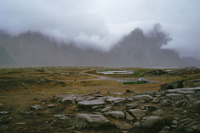 Scenic view of landscape against cloudy sky