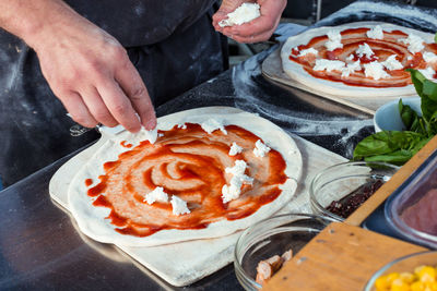 Midsection of person preparing food in restaurant