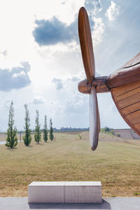 Windmill on field against sky