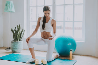 Young woman exercising at home