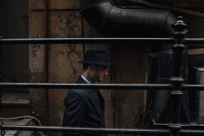 Side view of man against railing