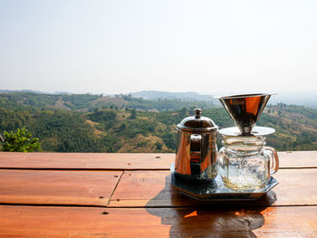 View of tea in glass on table against sky