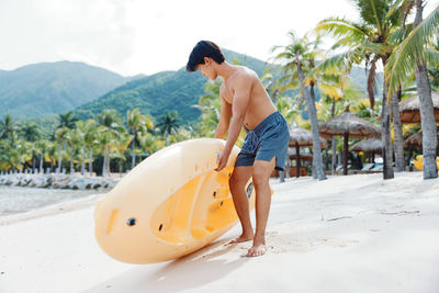 Rear view of shirtless man swimming in sea