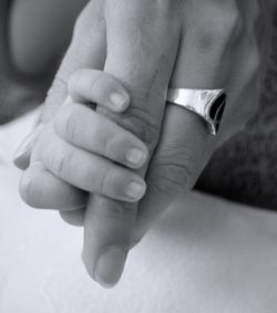 Cropped image of mother holding baby hand