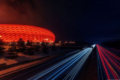 Football stadium at night. night lights. high angle view of light trails on road at night.