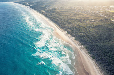 Byron bay australia. scenic view ocean beach patterned waves with white foam. travel and recreation