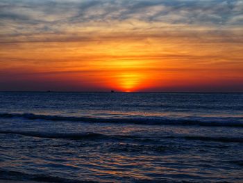 Scenic view of sea against orange sky