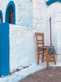 Empty chairs and tables in front of building