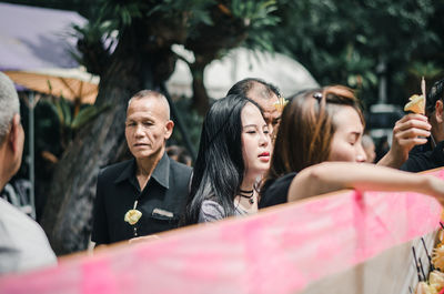 Portrait of people holding camera