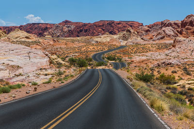 Road amidst landscape against sky