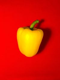 Close-up of bell peppers against red background