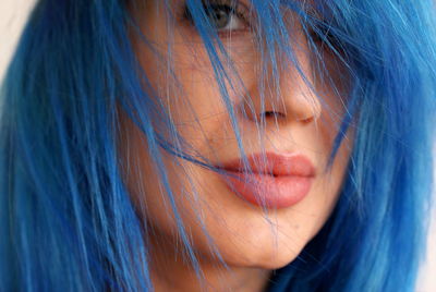 Close-up of young woman with blue dyed hair