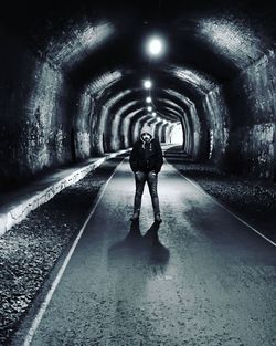 Full length of mid adult man standing in tunnel