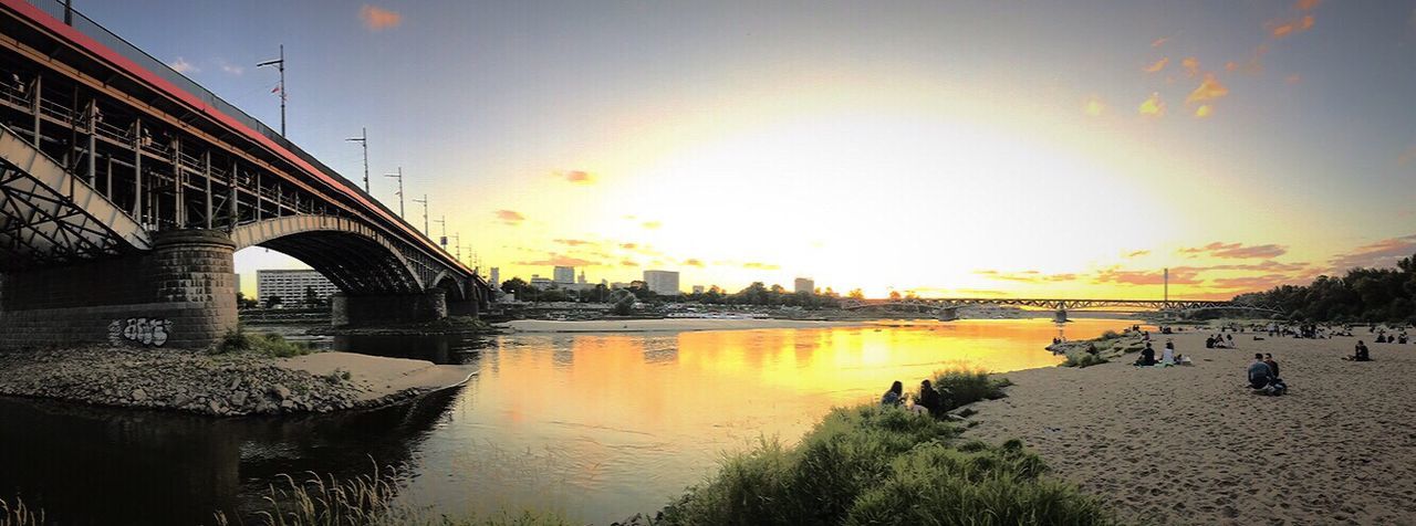 BRIDGE OVER RIVER AT SUNSET