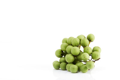 Close-up of grapes over white background