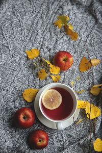 Cozy and soft autumn background. cup of tea and warm knitted sweater.