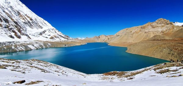 Scenic view of snowcapped mountains against clear blue sky