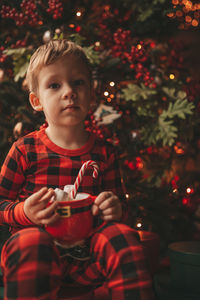 Portrait of cute girl playing with christmas tree