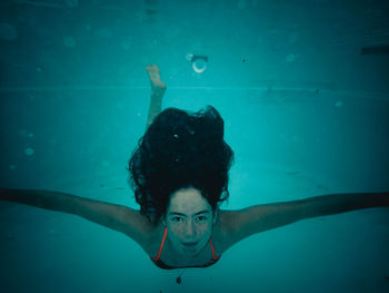 Portrait of woman swimming in sea