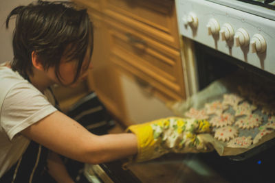 Side view of boy preparing food at home