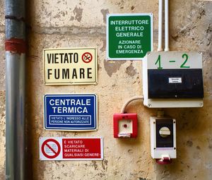 Warning signs and fuse boxes on wall