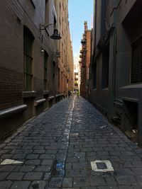 Empty alley amidst buildings in city
