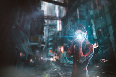 Woman standing on street in rain