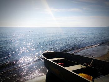 High angle view of boat moored at beach during sunny day