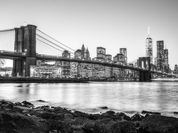 Bridge over river with buildings in background