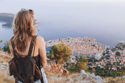 Back view of blond woman at dubrovnik viewpoint