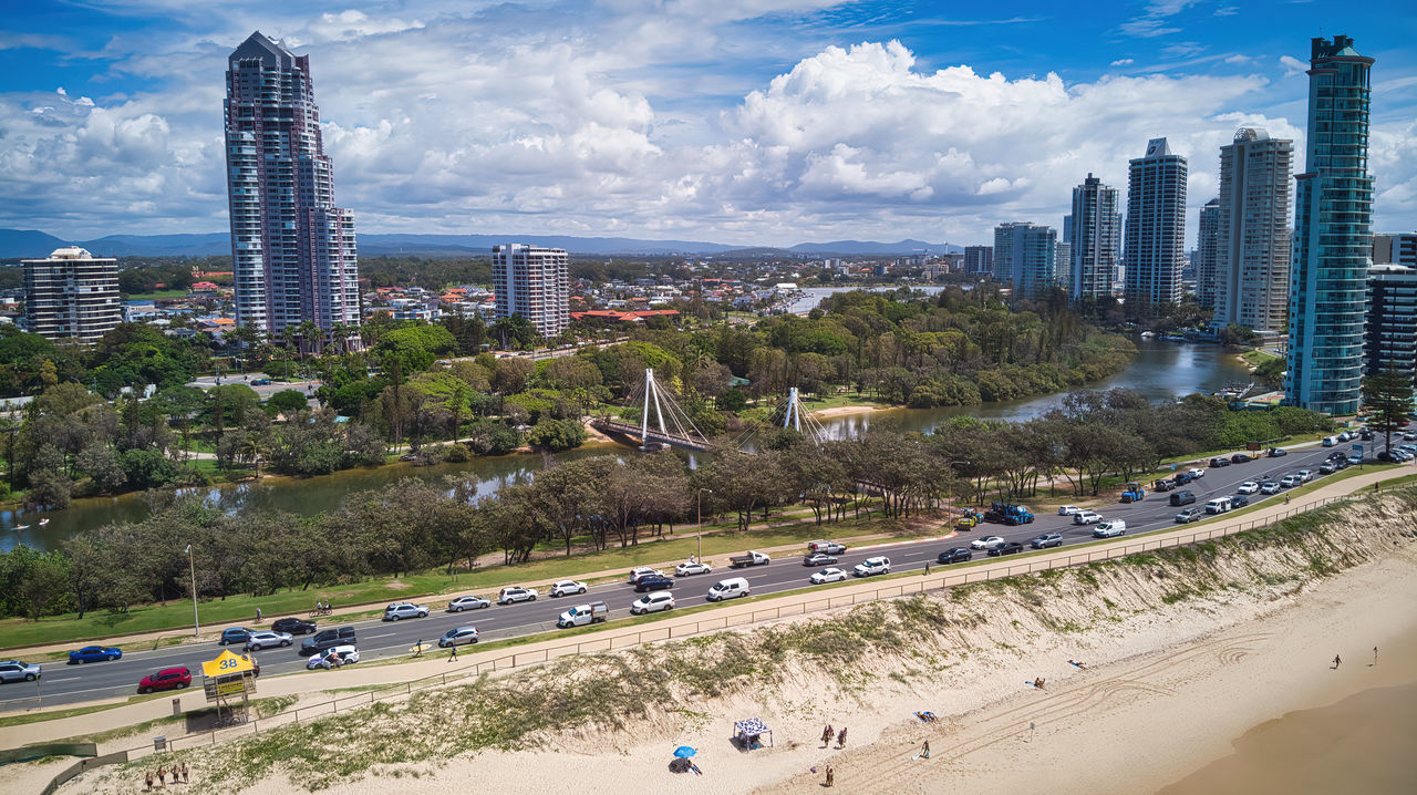 HIGH ANGLE VIEW OF STREET AND BUILDINGS AGAINST SKY