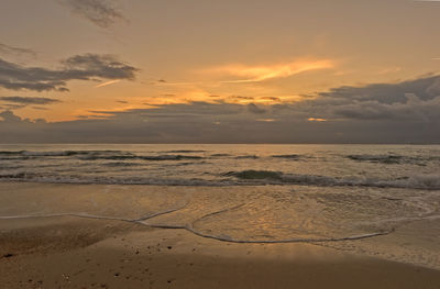 Scenic view of beach against sky during sunset