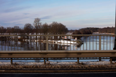 Pier over lake against sky during winter