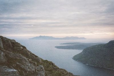 Scenic view of sea and mountains against sky