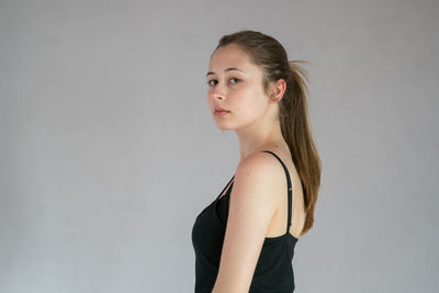 Portrait of a beautiful young woman against white background