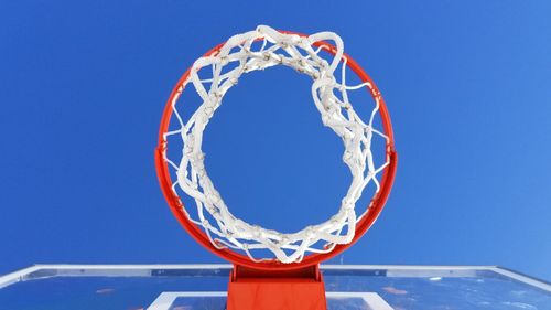 Low angle view of basketball hoop against clear blue sky