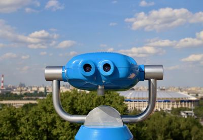 Close-up of coin-operated binoculars against sky