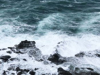 Waves splashing on rocks at shore